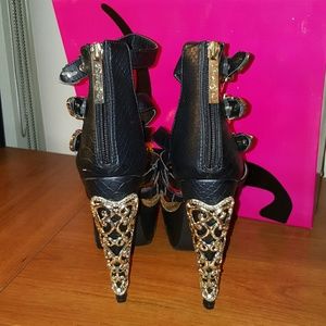 Black strappy heels with gold metal accents