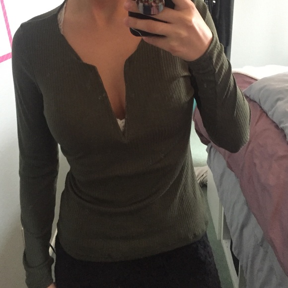 Olive green low v-neck cut long sleeve shirt.