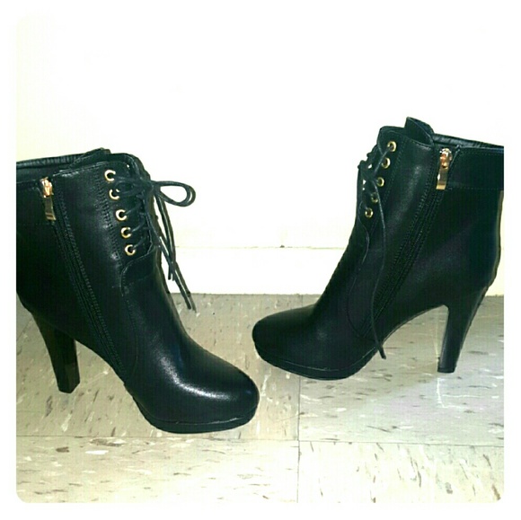 Black lace up boots with heel.