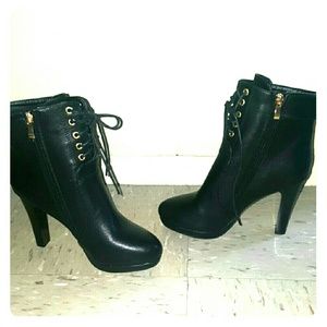 Black lace up boots with heel.