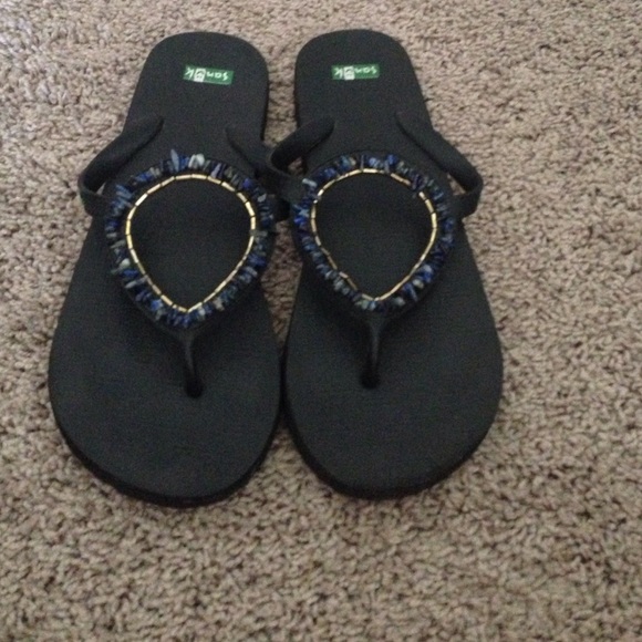 Blue lapis gold and black Sanuk flip flops