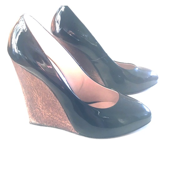 Black patent leather closed toe heels.