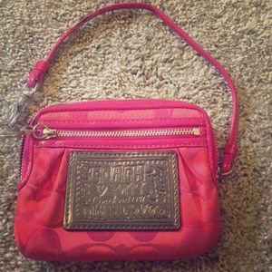 Coach wristlet, small stain on the strap shown.