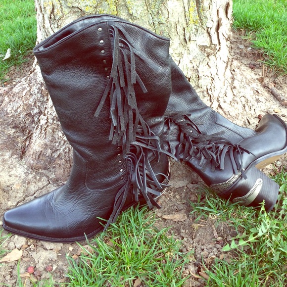 Black fringed cowboy boots with metal accents