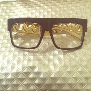 Plastic black and gold framed glasses.