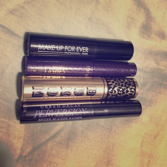 Four travel size mascaras of various brands