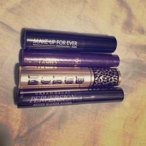 Four travel size mascaras of various brands