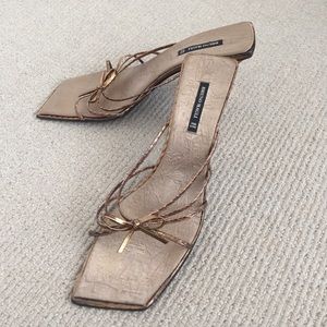 Bruno Magli bronze strappy slides.