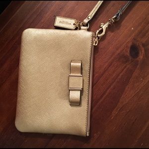 Gold coach wristlet with bow