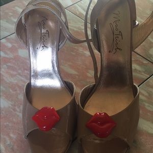 Nude patent strap heels with a kiss