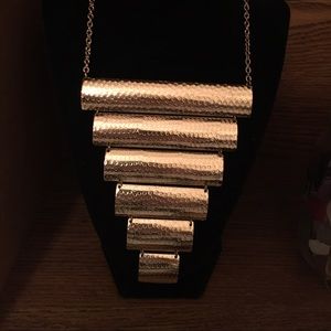 Gold bib necklace.
