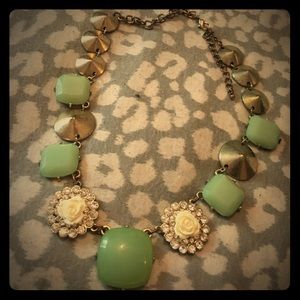 Light green jewel and white rose necklace.