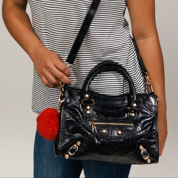 Gold studded moto handbag.