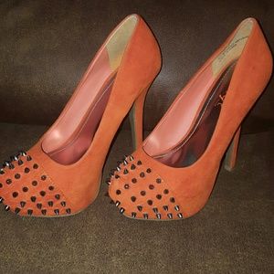 Orange pumps with spikes in the front