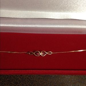 A gold bracelet with ruby and diamond accents