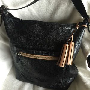 COACH large cross-body bag with adjustable strap.