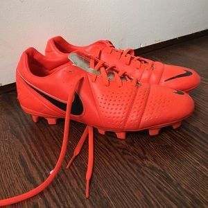 A pair of soccer cleats that are hotpink from Nike