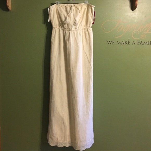 Cream colored strapless dress.