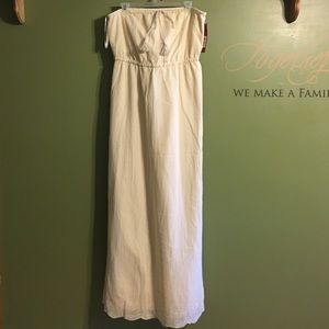 Cream colored strapless dress.