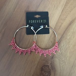Gold hoop earrings with coral accents