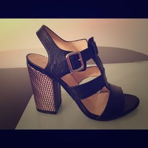 Marvin K heels black sandal with gold heel.