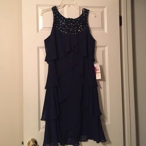 Ruffled cocktail dress cut-out & beaded detail.