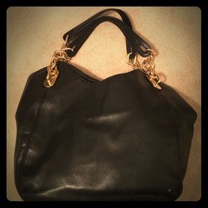 Black Michael Kors purse with gold chains