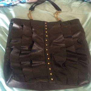 DSW black purse with ruffles and gold studs.