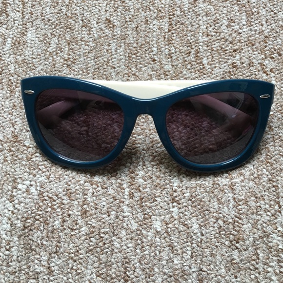 Teal sunglasses with black and white stripes