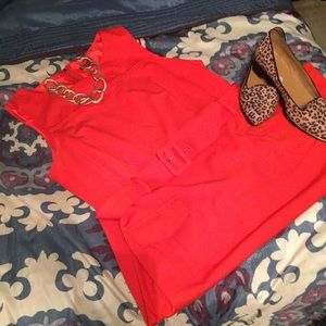 Belted redish orange knit dress.