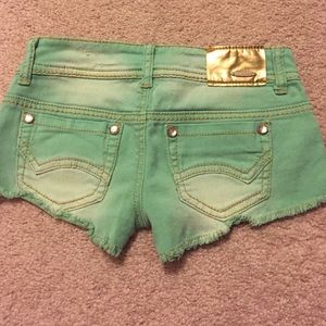 Dollhouse green distressed shorts