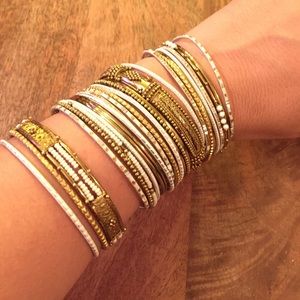 Set of white and gold bracelets