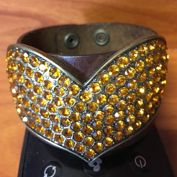 Leather cuff with gold heart.