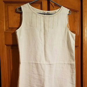 Knee length white dress; decoration on top