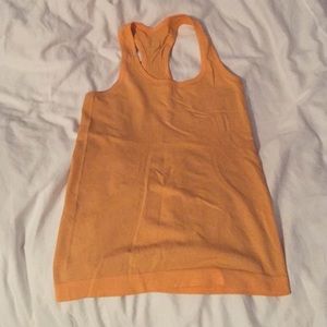 Orange Lululemon running top.