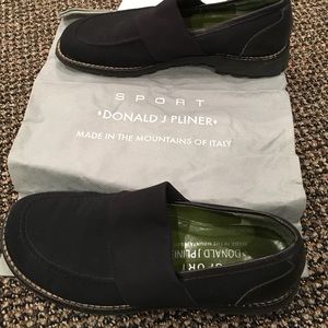 Black fabric loafer with white stitching around.