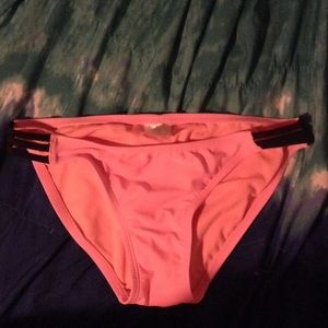Coral bikini bottoms with black side straps