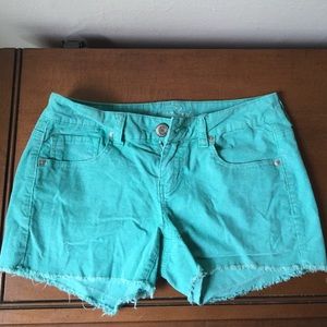 Bright green stretchy corduroy shorts.