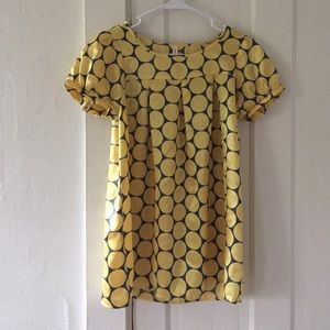 Yellow polka dot silk shirt.