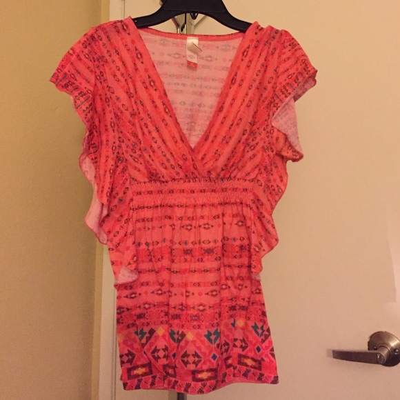 Orange V-neck printed shirt.