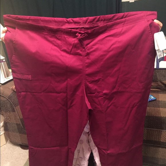 Four pairs of scrub pants and a scrub top