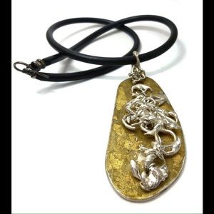 Silver sculpture on gold leaf pendant