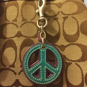 Coach peace sign accessory