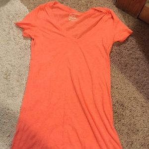 Bright orange v-neck shirt