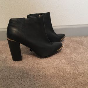 Black Asos booties with gold detail.