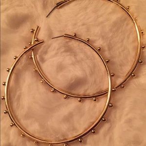 Gold studded hoops.