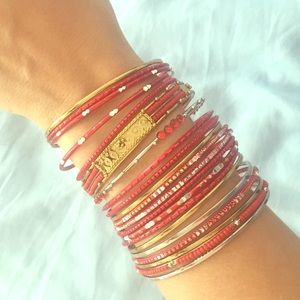 Set of gold and red bracelets