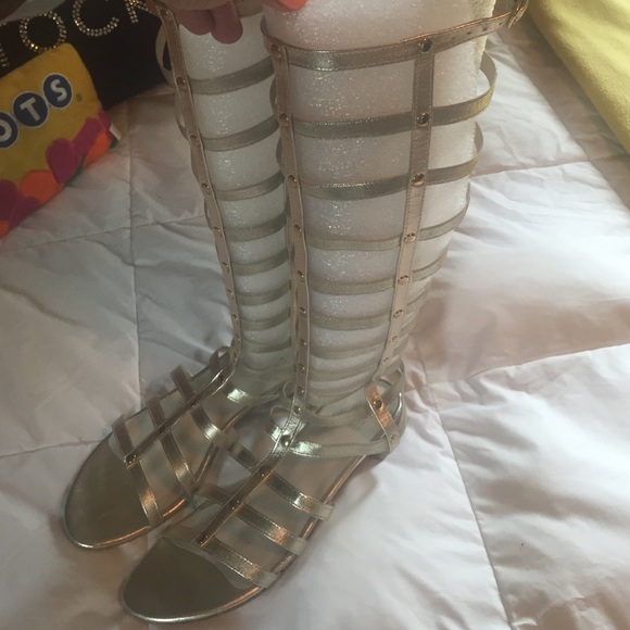 Stuart Weitzman gold gladiator sandals.