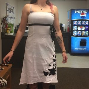 White dress with black flowers.