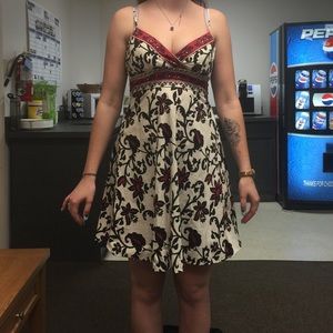 White dress with black and red floral pattern.